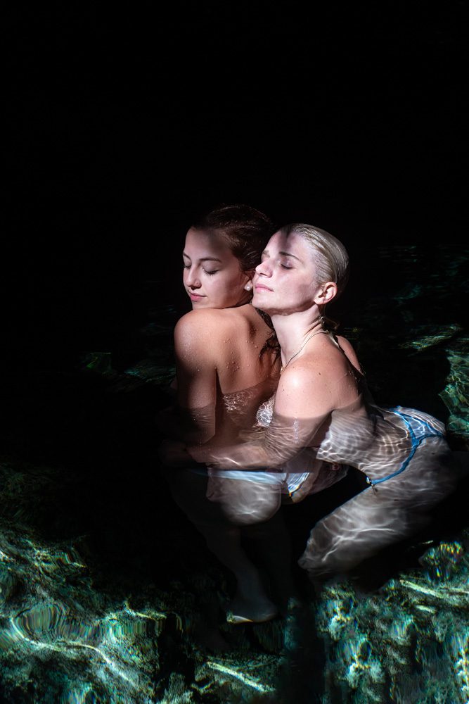 two girls in love hugging each other for a photo session in a cenote in tulum