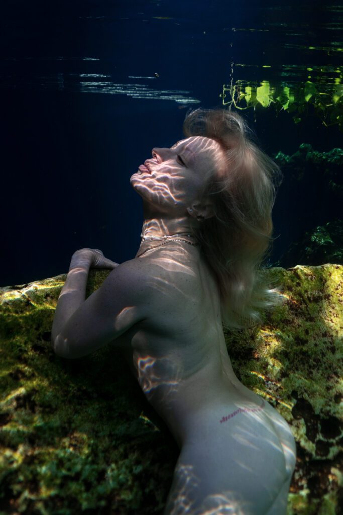 incredible underwater portrait of a blonde woman in the cenotes of tulum