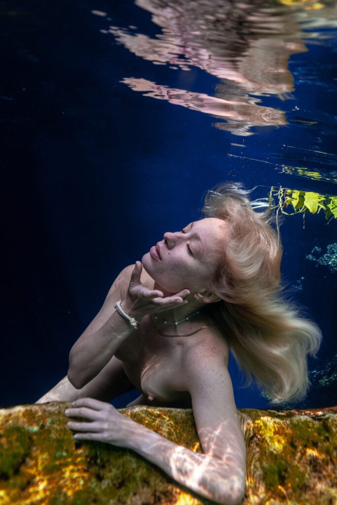 amazing underwater portrait of a woman with vibrant colors in cenote