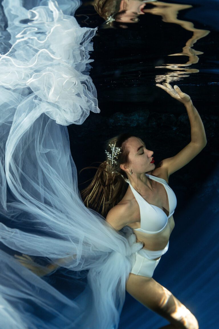 "underwater girl portrait in cenote with a white flowing dress"